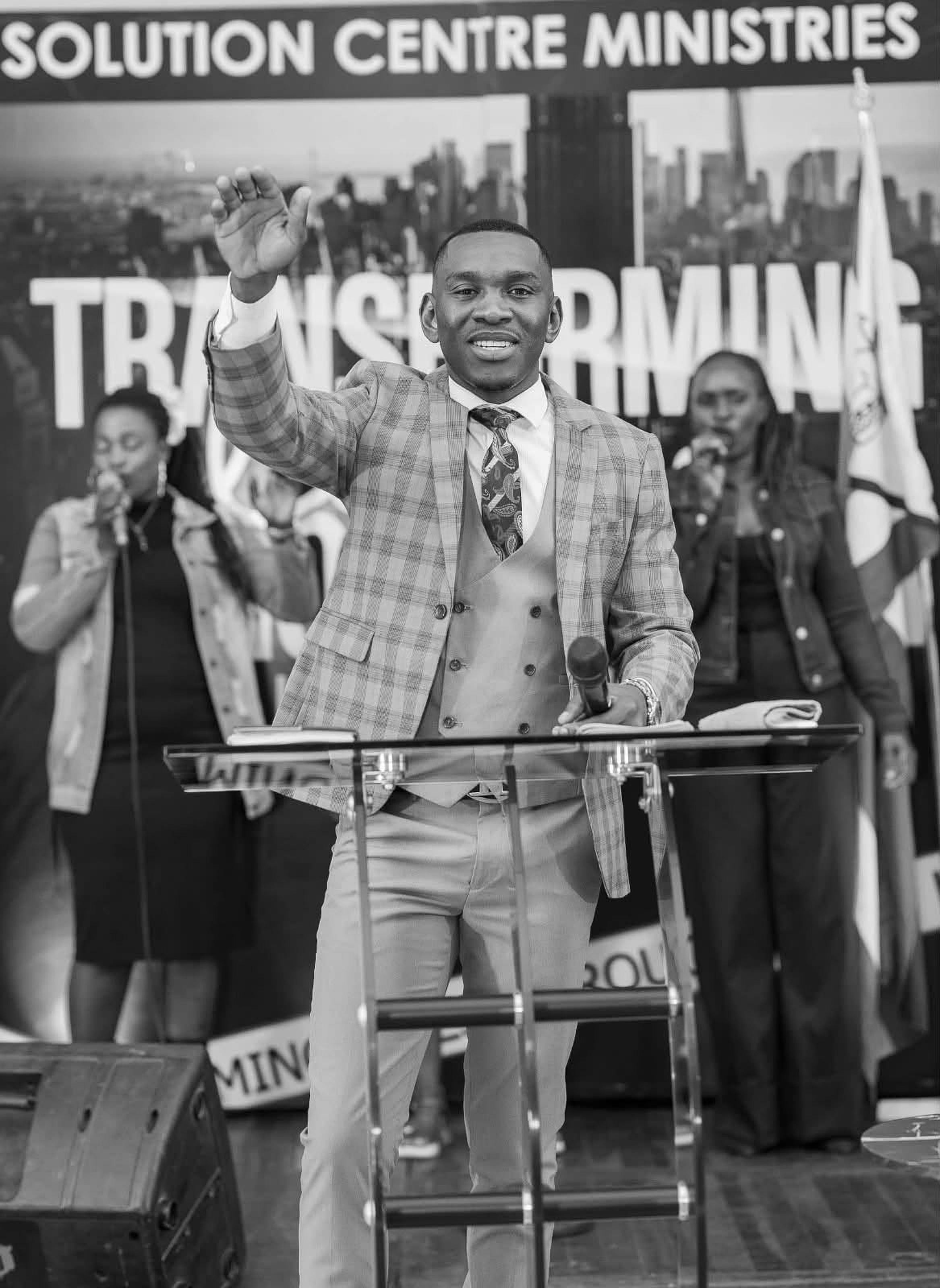 Prophet Elijah, founder of Solution Centre, greeting the congregation from the pulpit